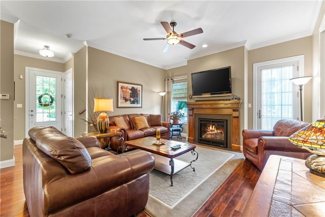 1 Riverfront St, Oakmont, PA 15139 - living room featuring dark wood-type flooring, a ceiling fan, a warm lit fireplace, and crown molding