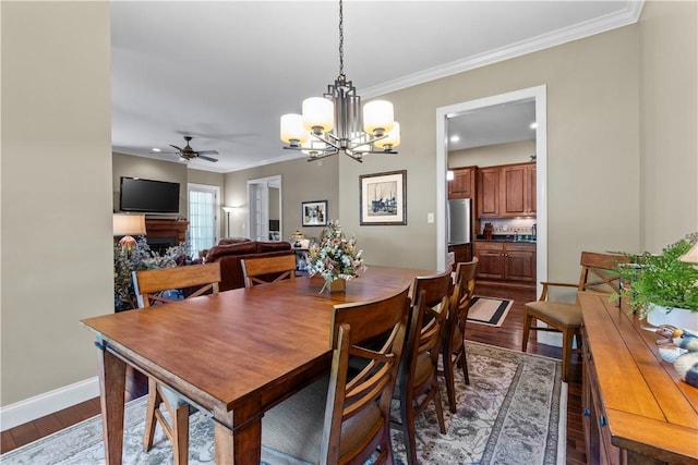 1 Riverfront St, Oakmont, PA 15139 - dining room featuring dark wood-style floors, ceiling fan, a chandelier, and crown molding