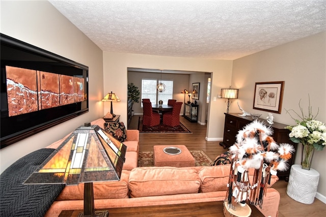 121 Sedeca Dr, North Strabane, PA 15317 - living room with wood finished floors, a textured ceiling, and a chandelier