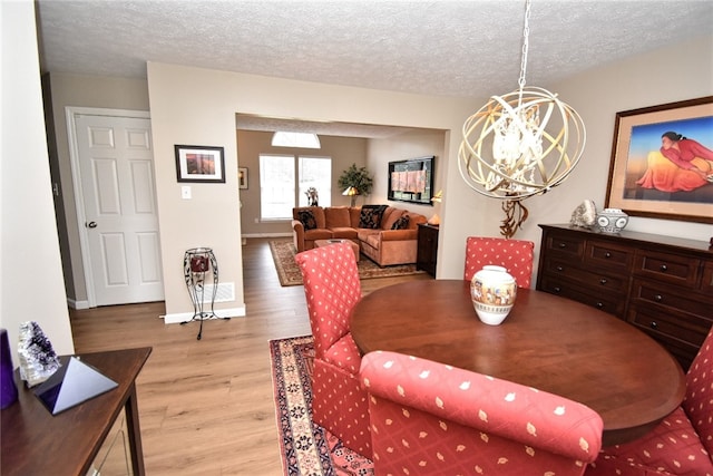 121 Sedeca Dr, North Strabane, PA 15317 - dining space with light wood finished floors, a chandelier, and a textured ceiling