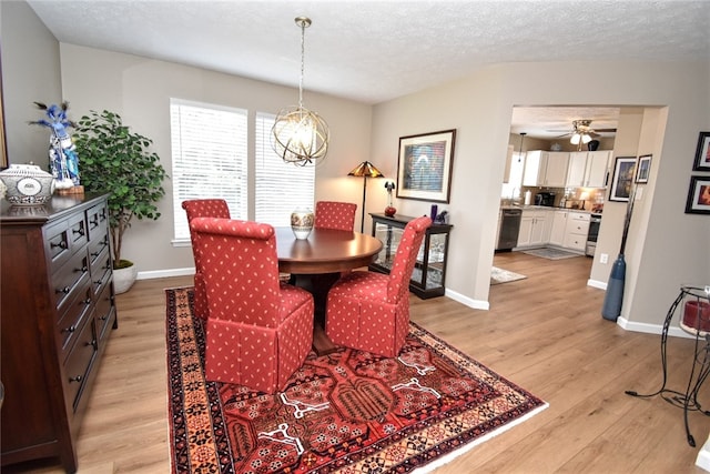 121 Sedeca Dr, North Strabane, PA 15317 - dining room with a chandelier, light wood-style floors, a ceiling fan, and a textured ceiling