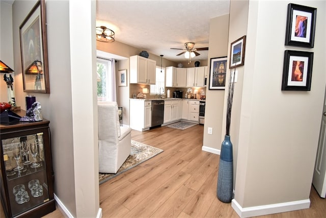 121 Sedeca Dr, North Strabane, PA 15317 - kitchen featuring stainless steel appliances, white cabinets, light wood-style floors, light countertops, and ceiling fan