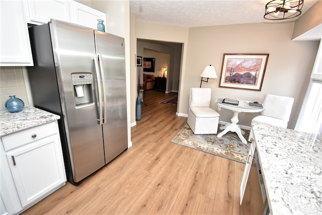 121 Sedeca Dr, North Strabane, PA 15317 - kitchen featuring stainless steel fridge, white cabinetry, light wood-type flooring, decorative backsplash, and a textured ceiling