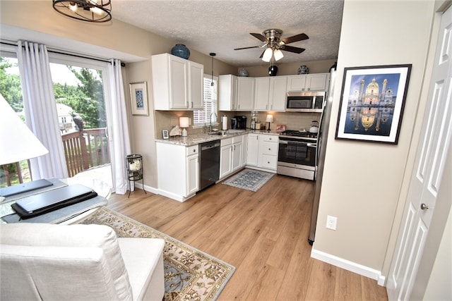 121 Sedeca Dr, North Strabane, PA 15317 - kitchen featuring stainless steel appliances, white cabinets, light wood-type flooring, tasteful backsplash, and a textured ceiling