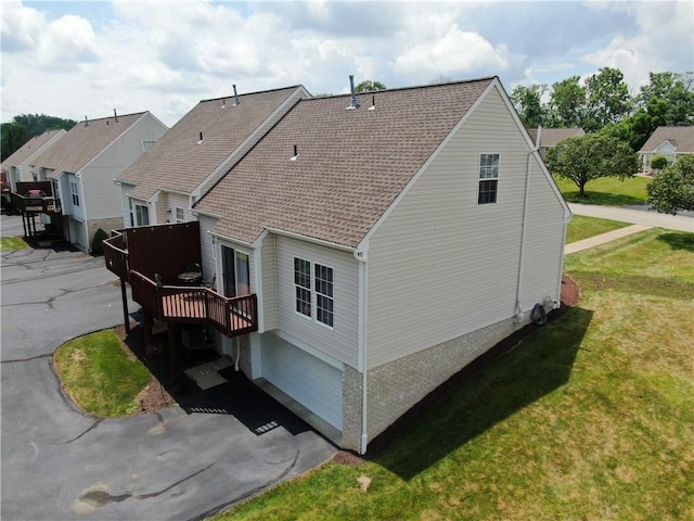 121 Sedeca Dr, North Strabane, PA 15317 - view of side of home with a lawn, a deck, a garage, a shingled roof, and asphalt driveway