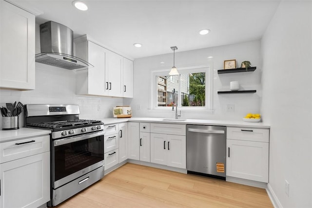 5110 Duncan St, Lawrenceville, PA 15201 - kitchen featuring stainless steel appliances, wall chimney exhaust hood, open shelves, light countertops, and white cabinetry