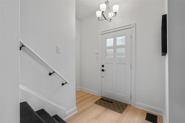 5110 Duncan St, Lawrenceville, PA 15201 - entrance foyer with wood finished floors, a chandelier, and stairs