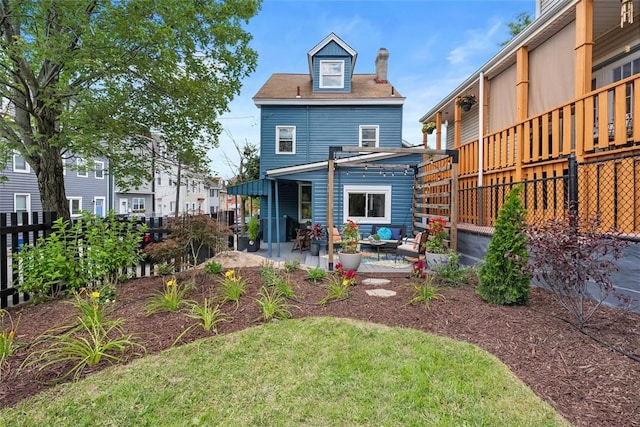 5110 Duncan St, Lawrenceville, PA 15201 - rear view of property featuring a patio, an outdoor hangout area, and a chimney