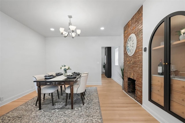 5110 Duncan St, Lawrenceville, PA 15201 - dining area featuring a chandelier, light wood-type flooring, a fireplace, and recessed lighting