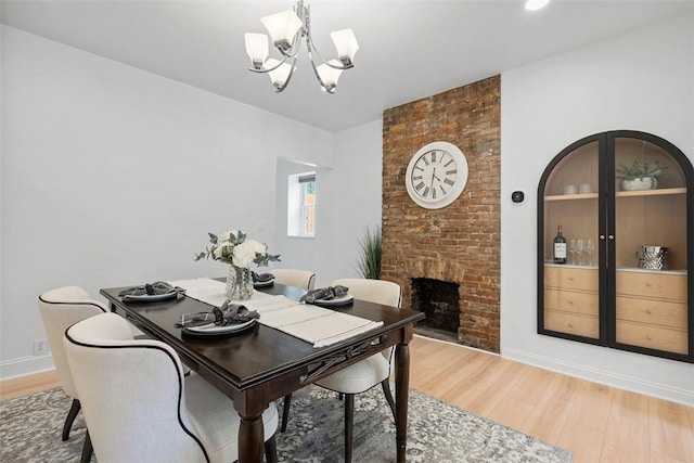 5110 Duncan St, Lawrenceville, PA 15201 - dining area with a chandelier, light wood-style floors, and a fireplace
