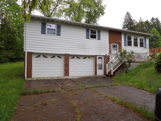 319 Robin Dr, Franklin, PA 16323 - split foyer home featuring brick siding, an attached garage, and driveway