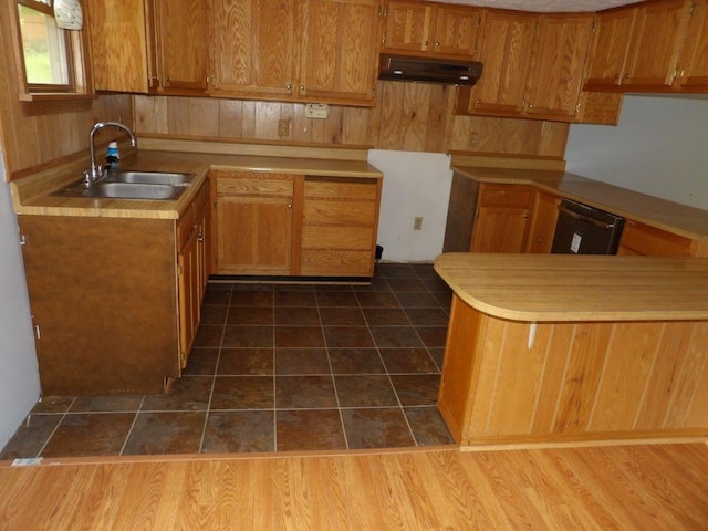 319 Robin Dr, Franklin, PA 16323 - kitchen with under cabinet range hood, brown cabinets, dishwasher, and dark tile patterned floors