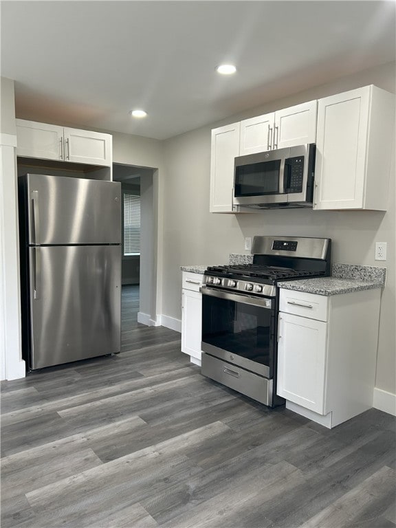 122 Church Ave, Shaler, PA 15116 - kitchen featuring appliances with stainless steel finishes, white cabinets, wood finished floors, recessed lighting, and light stone counters