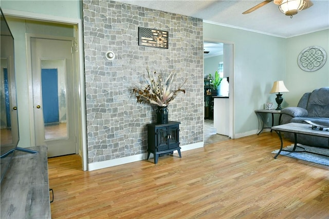 114 10th St, Pymatuning Twp, PA 16125 - living area featuring a wood stove, wood finished floors, crown molding, and a ceiling fan