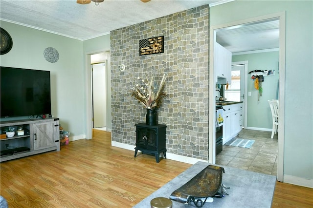 114 10th St, Pymatuning Twp, PA 16125 - living room with ornamental molding, a wood stove, and wood finished floors