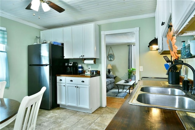 114 10th St, Pymatuning Twp, PA 16125 - kitchen with freestanding refrigerator, white cabinets, a ceiling fan, crown molding, and butcher block counters