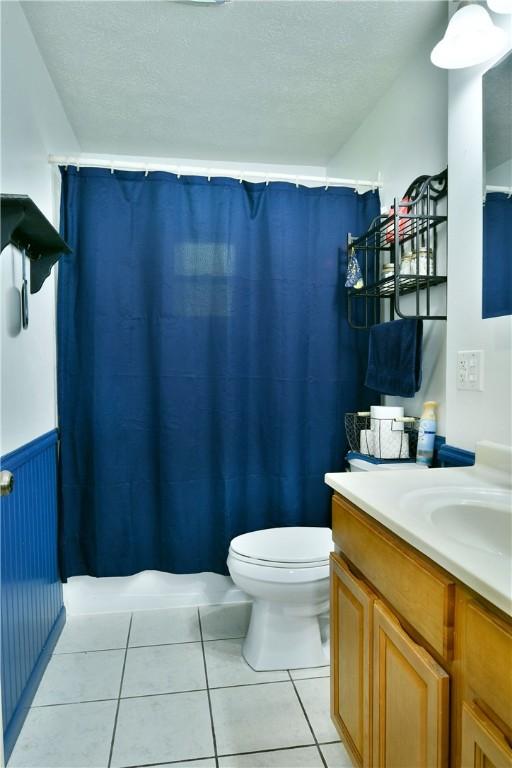 114 10th St, Pymatuning Twp, PA 16125 - full bath with vanity, tile patterned flooring, a textured ceiling, and a shower with curtain