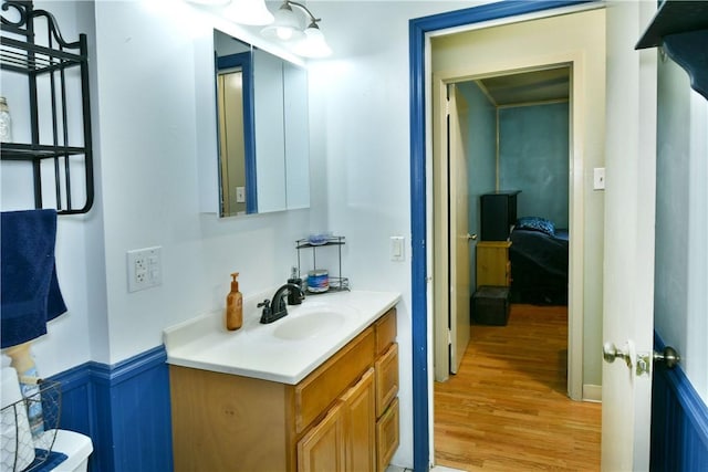 114 10th St, Pymatuning Twp, PA 16125 - half bathroom featuring wood finished floors, vanity, and a wainscoted wall