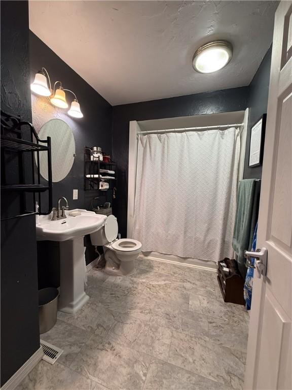 180 Beale Rd, Buffalo Twp, PA 16055 - bathroom featuring toilet and a shower with shower curtain