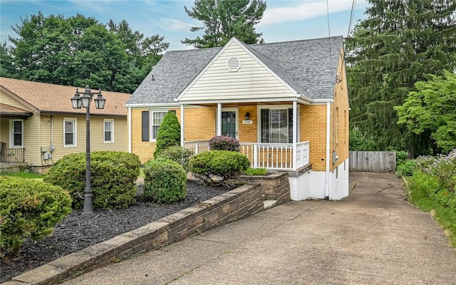 2514 Oakwood Rd, Shaler, PA 15116 - view of front facade featuring a porch, brick siding, and roof with shingles