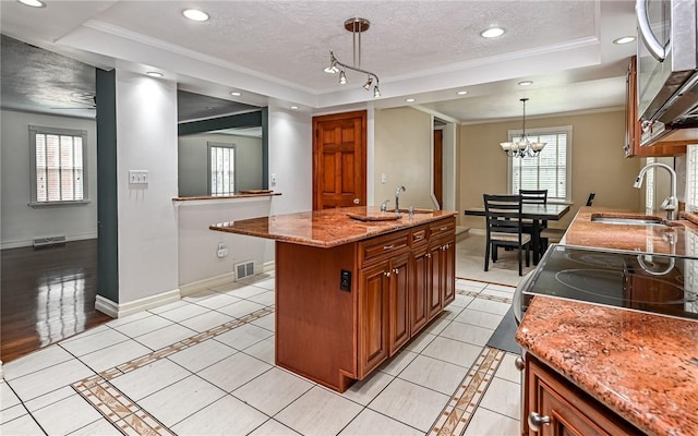 2514 Oakwood Rd, Shaler, PA 15116 - kitchen with a raised ceiling, a textured ceiling, stainless steel microwave, ornamental molding, and brown cabinetry