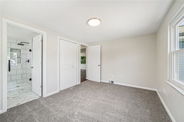1611 Guffey Rd, North Huntingdon, PA 15642 - unfurnished bedroom with multiple windows, ensuite bath, carpet floors, and a closet