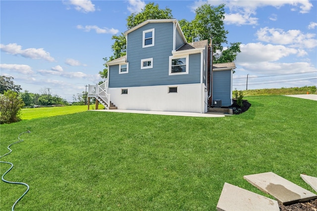 1611 Guffey Rd, North Huntingdon, PA 15642 - back of property featuring a yard, stairs, a shingled roof, and a patio area