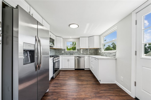 1611 Guffey Rd, North Huntingdon, PA 15642 - kitchen featuring stainless steel appliances, backsplash, dark wood-type flooring, and white cabinets