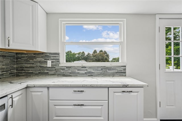 1611 Guffey Rd, North Huntingdon, PA 15642 - kitchen featuring white cabinetry, backsplash, and light stone counters