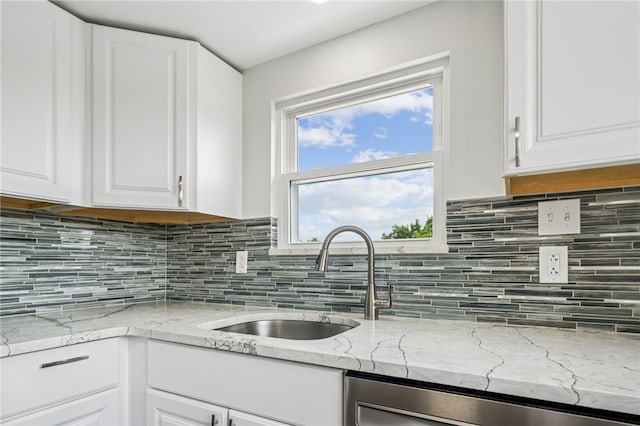 1611 Guffey Rd, North Huntingdon, PA 15642 - kitchen featuring dishwashing machine, white cabinetry, backsplash, and light stone counters