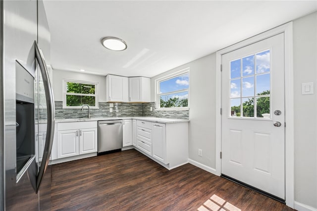 1611 Guffey Rd, North Huntingdon, PA 15642 - kitchen featuring appliances with stainless steel finishes, dark wood-style flooring, backsplash, and healthy amount of natural light