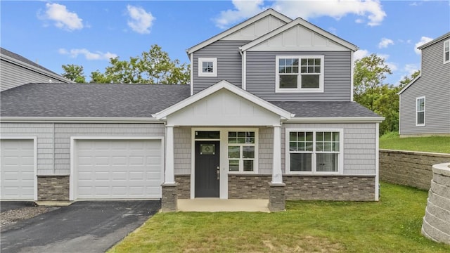 2215 Lebanon Dr, Elizabeth Twp/Boro, PA 15135 - view of front facade with board and batten siding, brick siding, a front lawn, and asphalt driveway