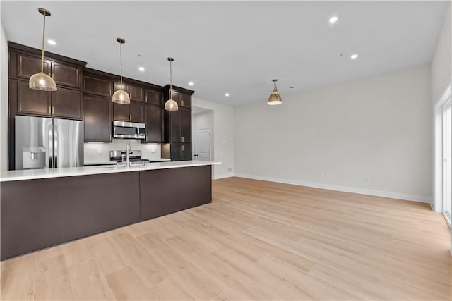 2215 Lebanon Dr, Elizabeth Twp/Boro, PA 15135 - kitchen with stainless steel appliances, light countertops, light wood finished floors, recessed lighting, and dark brown cabinetry
