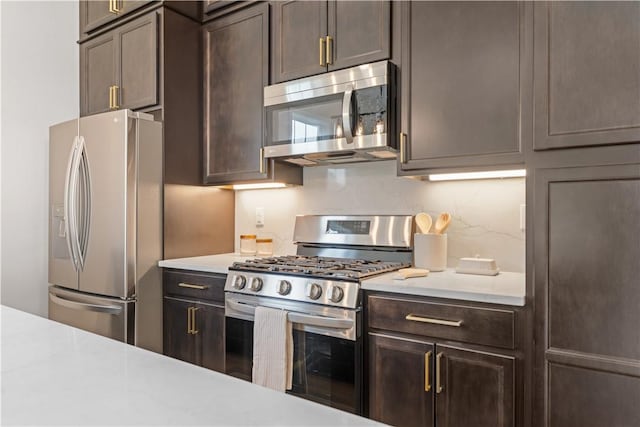 2219 Lebanon Dr, Elizabeth Twp/Boro, PA 15135 - kitchen with stainless steel appliances, light countertops, dark brown cabinets, and decorative backsplash