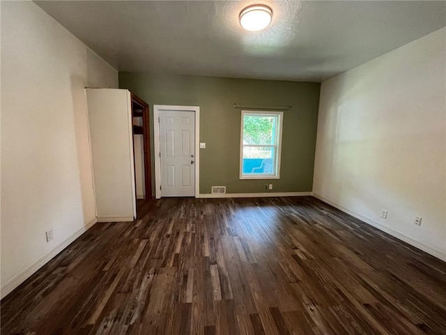 702 Sellers Ave, Jeannette, PA 15644 - empty room with dark wood-style floors and baseboards