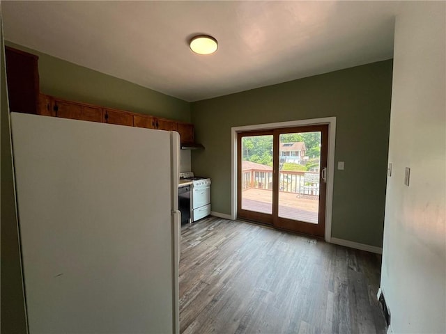 702 Sellers Ave, Jeannette, PA 15644 - kitchen with freestanding refrigerator, light wood-type flooring, under cabinet range hood, and brown cabinets