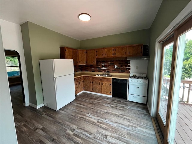 702 Sellers Ave, Jeannette, PA 15644 - kitchen featuring white appliances, plenty of natural light, light countertops, and decorative backsplash