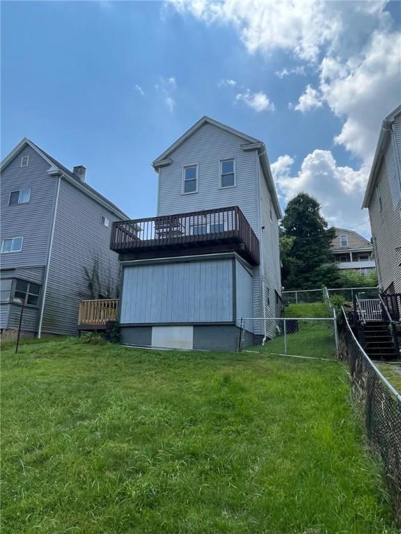 702 Sellers Ave, Jeannette, PA 15644 - back of property with a fenced backyard and a wooden deck