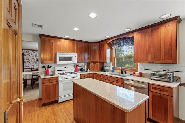 44 Stonehenge Dr, South Strabane, PA 15301 - kitchen featuring white appliances, light wood-type flooring, recessed lighting, tasteful backsplash, and a center island