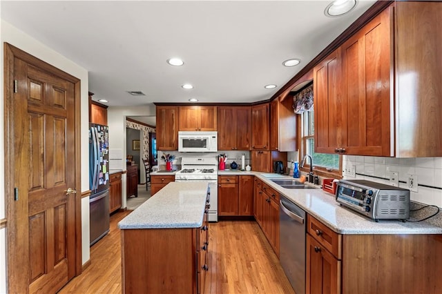 44 Stonehenge Dr, South Strabane, PA 15301 - kitchen featuring stainless steel appliances, a center island, recessed lighting, light wood-type flooring, and light stone countertops