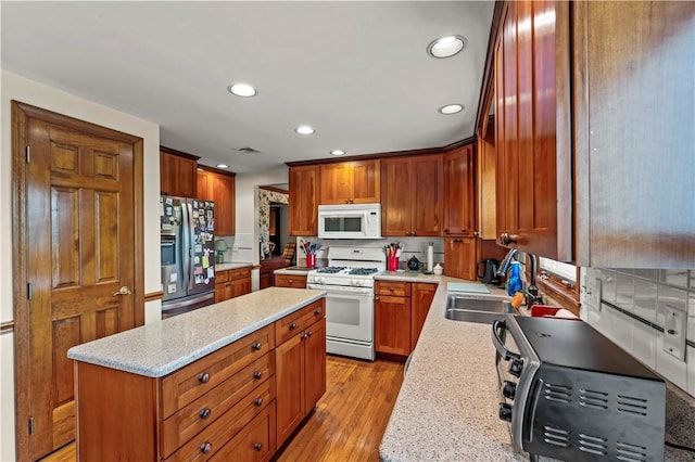 44 Stonehenge Dr, South Strabane, PA 15301 - kitchen featuring white appliances, a center island, recessed lighting, light wood-type flooring, and tasteful backsplash