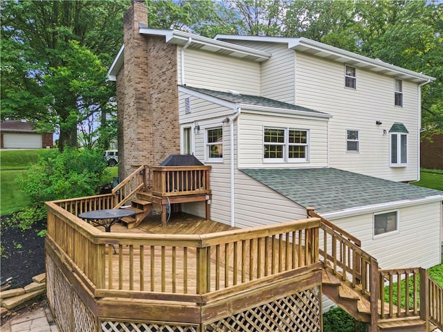 44 Stonehenge Dr, South Strabane, PA 15301 - back of property with a chimney, a deck, a shingled roof, and stairs