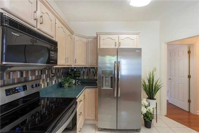 103 Boxwood Ct, Peters Twp, PA 15317 - kitchen featuring appliances with stainless steel finishes, decorative backsplash, dark countertops, and light tile patterned flooring