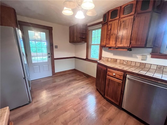 423 Bonniebrook Rd, Summit Twp, PA 16002 - kitchen with appliances with stainless steel finishes, tile countertops, a chandelier, light wood-type flooring, and open shelves