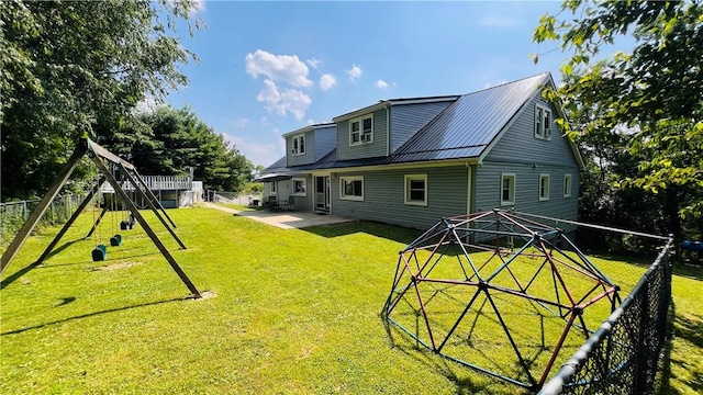 324 Paul Dr, Lower Burrell, PA 15068 - back of property with a playground, a fenced backyard, and a patio area