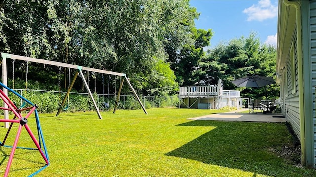 324 Paul Dr, Lower Burrell, PA 15068 - fenced backyard with a playground, a patio, and view of scattered trees