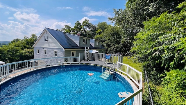 324 Paul Dr, Lower Burrell, PA 15068 - outdoor pool with a wooden deck and view of wooded area