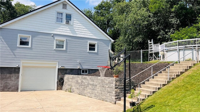 324 Paul Dr, Lower Burrell, PA 15068 - view of property exterior with an attached garage, concrete driveway, and stairway