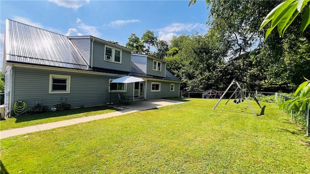 324 Paul Dr, Lower Burrell, PA 15068 - rear view of house with a patio, a metal roof, and a playground