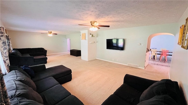 324 Paul Dr, Lower Burrell, PA 15068 - living room with arched walkways, a ceiling fan, light colored carpet, and a textured ceiling
